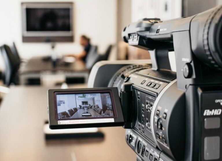 Corporate video production team filming office interview