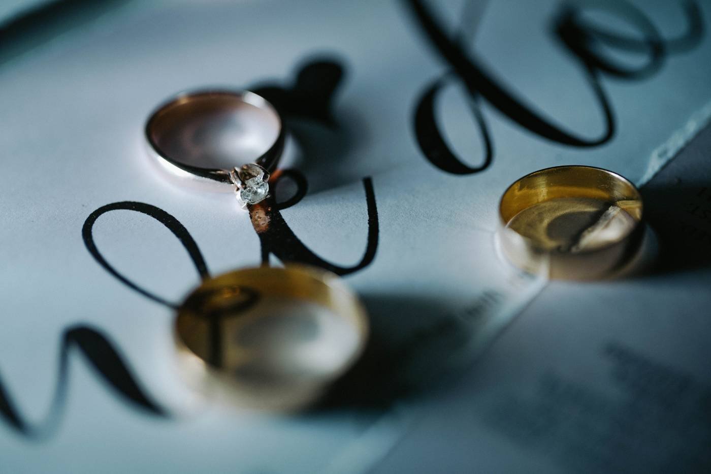 Wedding invitation suite and rings arranged for photography before the ceremony